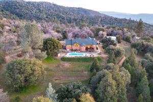 an aerial view of a house with a swimming pool at Yosemite Adventure House with Pool-hot tub-game room in Oakhurst