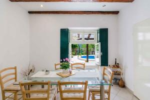 a dining room with a table and chairs at Holiday home in Drivenik 39517 in Drivenik