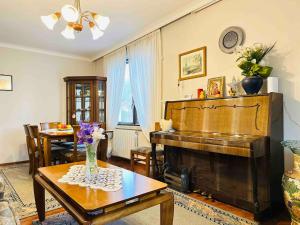 a living room with a piano and a table at Къща за гости Заркови in Gaber