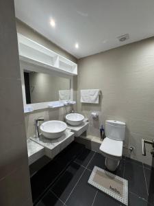 a bathroom with two sinks and a toilet and a mirror at Panoramic Family Apartment Agadir New in Agadir +27 photos