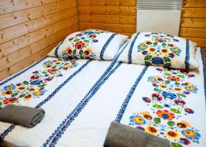 a bed with two pillows on top of it at Zielony Raj - Bieszczady in Wańkowa