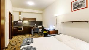 Ένα ή περισσότερα κρεβάτια σε δωμάτιο στο eFi Palace Hotel