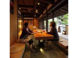 two women sitting at a table in a restaurant at Yumoto Onsen OharaSansou - Vacation STAY 27617v in Kyoto