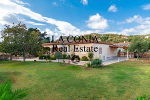 a house with a sign that reads zealani real estate at blue sea villa in Cannigione