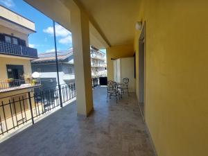 a balcony with two chairs and a table on it at B&B mirò e appartamenti in Marina di Gioiosa Ionica