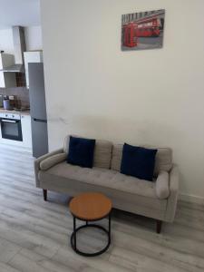 a living room with a couch and a table at Central Wigan Stay in Wigan +4 photos