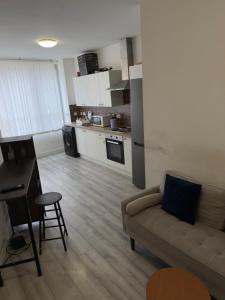 a living room with a couch and a kitchen at Central Wigan Stay in Wigan