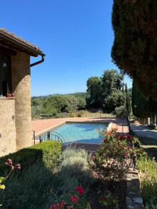 a swimming pool in front of a house at Podere Le Grotte in San Gimignano