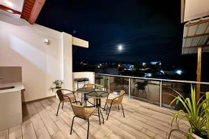 Un patio con una mesa y sillas en un balcón. en Vive a 5min centro 2HAB con A/C Terraza y Parrilla, en Tarapoto