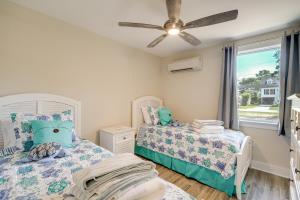 a bedroom with two beds and a ceiling fan at Private Dock and Beach Access Outer Banks Area Home in Kill Devil Hills +36 photos