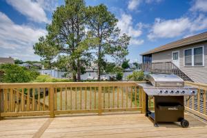 a grill on a wooden deck in front of a house at Private Dock and Beach Access Outer Banks Area Home in Kill Devil Hills