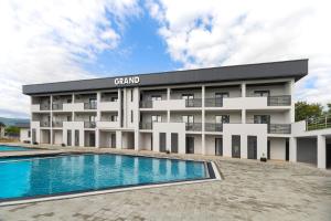 a building with a swimming pool in front of it at GRAND Hotel NEW 2025 in Solotvyno +48 photos