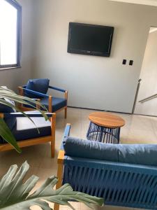 TV a/nebo společenská místnost v ubytování Pousada Ramilos - by Easy Hotéis