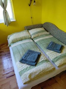 a bed with two pillows on it in a room at Chata Teodor in Betlanovce