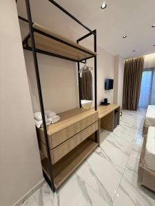 a room with a bed and a desk with a mirror at Azure Waves in Vlorë