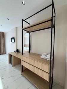 a room with a bunk bed with a mirror at Azure Waves in Vlorë