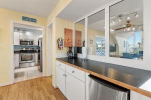 a kitchen with white cabinets and a counter top at Fun2Sea in Corolla