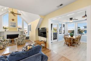 a living room with two couches and a table at Fun2Sea in Corolla