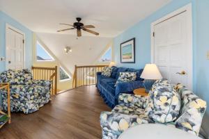 a living room with two couches and a ceiling fan at Fun2Sea in Corolla +37 photos