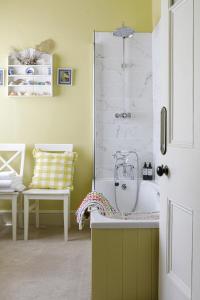 a bathroom with a shower with a sink and a tub at Trewardale in Bodmin +47 photos