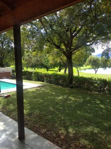 a view of the yard from the porch of a house at Pecanwood Villa with lake view in Hartbeespoort