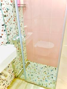 a shower with a glass door with a toilet at Happy Sweet Apartment in Niš +10 photos