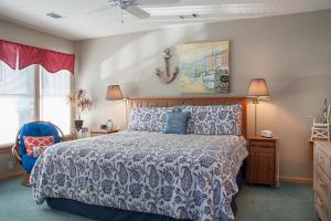 a bedroom with a bed and a painting on the wall at Gone Fishin in Nags Head +25 photos