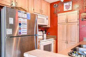 a kitchen with a stainless steel refrigerator and white cabinets at Gone Fishin in Nags Head