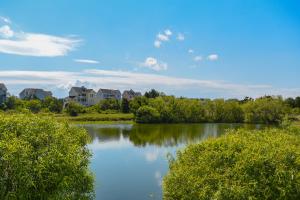 a view of a river with houses in the background at Gone Fishin in Nags Head