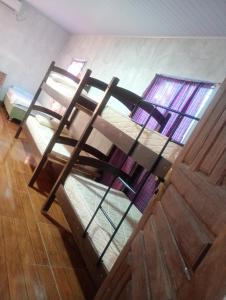 a pair of bunk beds in a room at Hostel Lençóis em Santo Amaro MA in Santo Amaro