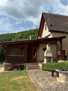 a house with a large bell on the front of it at Forestin Vendégház in Nagymaros +22 photos