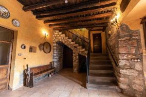 a staircase in a building with a stone wall at Can Ollé in Rubio