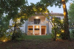 a house in the middle of a yard with trees at Casale Trifoglio in Morano Calabro