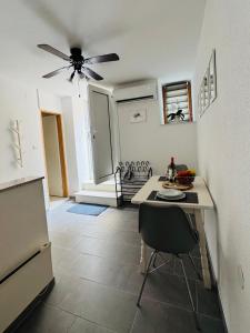 a kitchen with a table and a ceiling fan at Z&D - Korak do mora in Mali Lošinj +6 photos