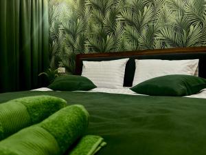 a bedroom with a bed with green sheets and pillows at Stop Time in Slavske +27 photos