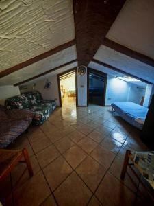 une chambre avec un lit et un canapé dans une pièce dans l'établissement Santa Teresa mansarda parking centro, à Santa Teresa Gallura