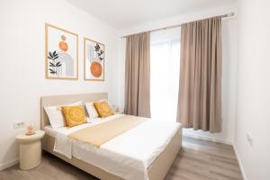 a bedroom with a bed and a window at Soni Exclusive Apartments 1218 Plaza with Private Parking & Self Check-in in Bucharest