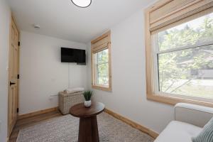 a living room with a couch and a window at BrookHaus - Modern Cabin Stay at Harvard Brook in Lincoln