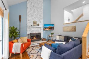 a living room with couches and a fireplace at La Maison du Lac in Sawyer