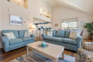 a living room with two blue couches and a table at Harrells Retreat in Nags Head