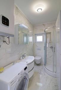 a bathroom with a sink and a shower and a toilet at Villa Nada in Banići