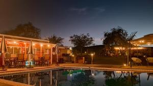a swimming pool in front of a house at night at Jimmy & Yudy's place in El Triunfo