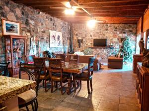 a dining room with a table and chairs and a christmas tree at Jimmy & Yudy's place in El Triunfo