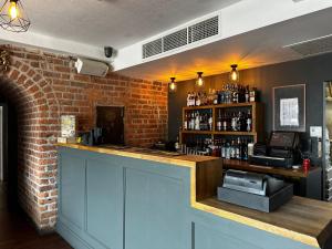 a bar in a restaurant with a brick wall at White Star Line Hotel in Liverpool