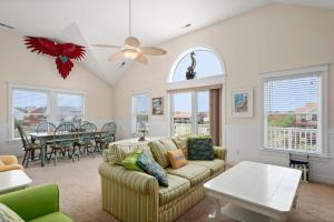 a living room with a couch and a table at Haven Of Rest in Nags Head