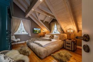 two beds in a room with wooden ceilings at Landhaus-zum-Wilddieb in Ilsenburg