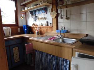 a kitchen with a sink and a counter top at Gartenlandhaus in Dohma