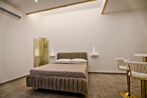 a bedroom with a bed and a table and chairs at Dante Luxury Rooms in Naples