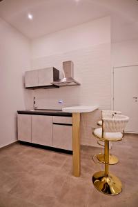 a kitchen with a table and a chair and a counter at Dante Luxury Rooms in Naples