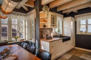 Una cocina con mesa y sillas y ventanas. en Landhaus-Serpentine, en Ilsenburg 18 fotos más